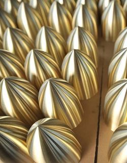 The image shows precision-manufactured copper spun components with polished surface finish, demonstrating high repeatability and surface consistency in batch production.